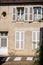 Old house facade with shutter and white door