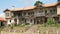 Old house with garden and beautiful stone vases