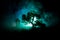 Old house with a Ghost in the forest at night or Abandoned Haunted Horror House in fog. Old mystic building in dead tree forest. T