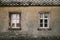 Old house grey facade with wooden windows