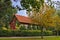 Old house immersed in autumn greenery