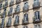 Old house with many windows. Windows background. Historic building with a lot of windows and balconies. Window and balcony.