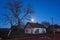 Old house at night,house of horrors on the outskirts of the village at night with a full moon and a dead tree