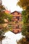 Old house with reflection in the pond