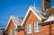 Old house with snow on pitched roof, UK winter