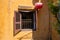 Old house window with shutter, yellow wall and red lantern. Hoi An historical town architecture detail