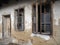 Old house with windows and a door. Collapsing rural house. The concept of urbanization and oblivion of the motherland. Abandoned