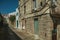 Old house with worn plaster wall and narrow alley