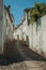 Old house and worn plaster walls in cobblestone alley