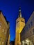 Old houses and the Baptist Church of St. Olaf on one of the streets of Old Tallinn against the dark blue sky. Spring evening