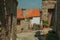 Old houses and flowered pots on cobblestone alley