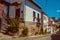 Old houses with flowering pots and deserted alley