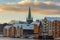 Old houses and magazines by Nidelva river in Trondheim, Nidarosdomen Cathedral in back