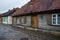 Old houses near brick road and path with wooden exterior