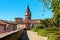 Old houses, park and belfry under blue sky in Govone, Italy.