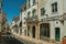 Old houses with peeling plaster in a deserted street at Elvas