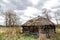 Old houses and sheds with a roof covered with reeds using old-fashioned technology in the Polesie