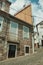 Old houses with stone wall in a deserted alley