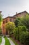 Old houses with tiled roofs and turrets against a cloudy sky in Milan, Italy