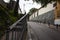 Old houses, vegetation, leafy trees, lonely narrow street and old iron railing with ornament and a bit of rust El Hatillo Miranda