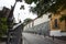 Old houses, vegetation, leafy trees, lonely narrow street and old iron railing with ornament and a bit of rust El Hatillo Miranda