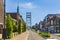 Old houses and vertical lift bridge crossing the river Gouwe at the picturesque village Boskoop, the Netherlands