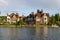 Old houses and a white canoe over river Thames, Marlow