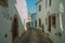 Old houses with whitewashed wall in an alley of Marvao