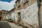 Old houses with worn plaster on deserted alley