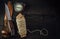 Old hunting bushcraft knife, compass and a linen rope on the wooden table.