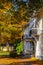 Old idyllic wooden house in a park in autumn