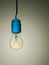Old incandescent light bulb with bad wiring, sight