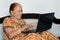 Old indian lady happy using laptop and internet.