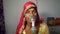 Old Indian woman infected with Covid 19 disease. Patient inhaling oxygen wearing mask with liquid Oxygen flow