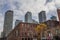 Old individual houses surrounded by high rise condo apartment building towers on Queen Street, in an area of downtown Toronto bei