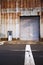 Old industrial building with rusty shell and big gate