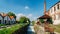 Old industrial warehouses alongside a cascade on a lock at the Naviglio Pavese, a canal that connects the city of Milan with Pavia