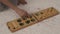 Old intelligence games, wooden mancala game, a person playing mancala