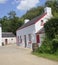 Old Irish Traditional Whitewashed Cottage on Farm in Ireland