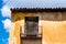 Old Iron Balcony in Aged Yellow Plaster Facade