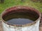 Old iron barrel with water in the garden