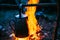 Old Iron Camp Kettle Boils Water On A Fire In Forest. Bright Flame Fire