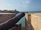 Old iron cannon at defensive wall at sea