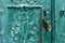 Old iron door, forged and painted in green color with golden flowers for background, vintage style, retro elements