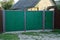 Old iron gates and wicket green on the street in the grass