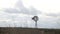 Old iron windpump windmill spinning in nature