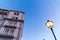 Old Italian apartment buildings on a sunset with a blue sky and street lamp. Facade of apartment building, hotels, hostels