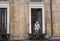 Old italian lady sweeping balcony. Catania, Sicily. Italy