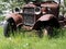 Old Jalopy Rusting Away In Tall Grass