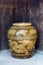 Old Japanese glazed earthenware or ceramic jar with dragon pattern design used as water container